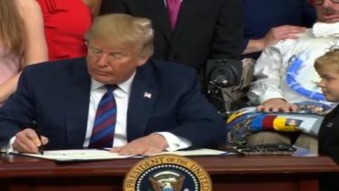 President Trump with Jordan McLinn after signing the "Right To Try" Act. Image credit to US4Trump screen capture