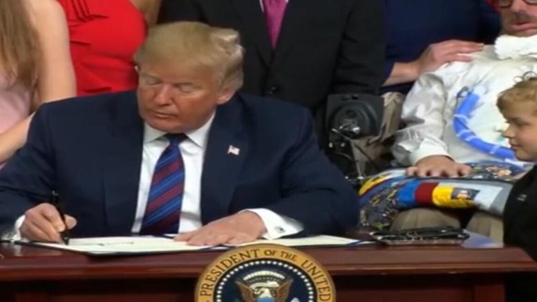 President Trump with Jordan McLinn after signing the "Right To Try" Act. Image credit to US4Trump screen capture